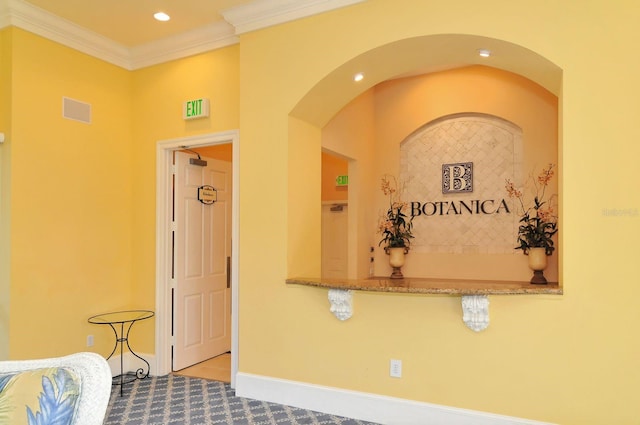 interior space featuring visible vents, recessed lighting, baseboards, and ornamental molding