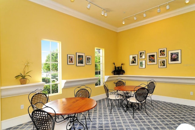 dining room featuring crown molding and baseboards