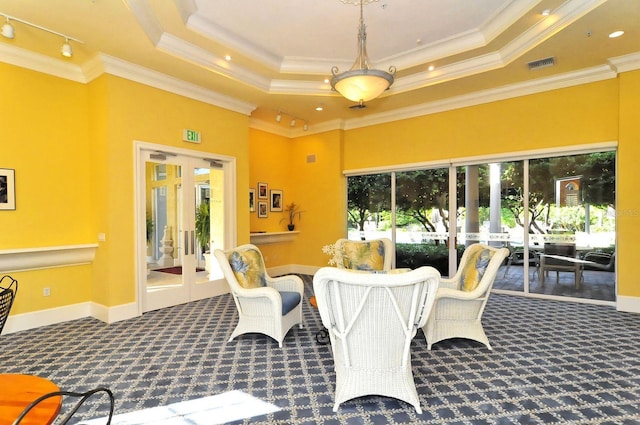 dining room with a raised ceiling, carpet flooring, visible vents, and ornamental molding