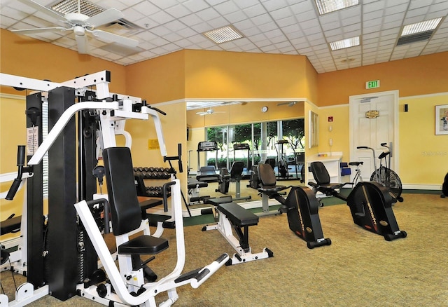 exercise room featuring a paneled ceiling, visible vents, carpet floors, and ceiling fan