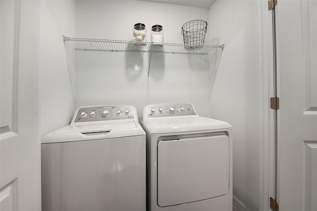 clothes washing area with laundry area and washer and clothes dryer