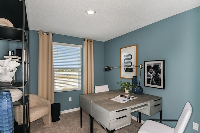 carpeted office featuring baseboards and a textured ceiling