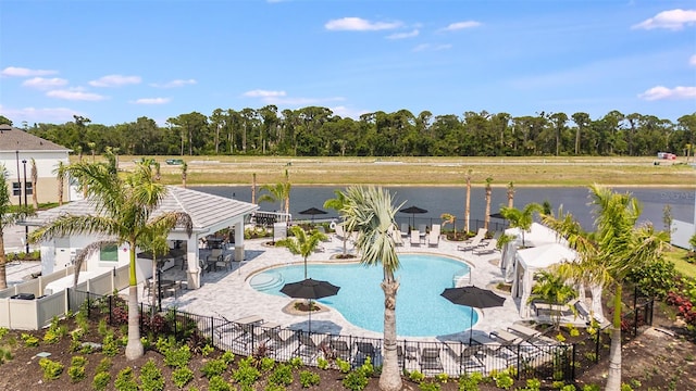 pool with a gazebo, a patio area, fence, and a water view