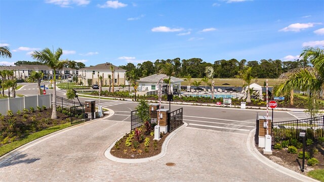 surrounding community with fence and a residential view