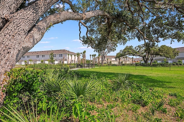 view of yard featuring fence and a residential view