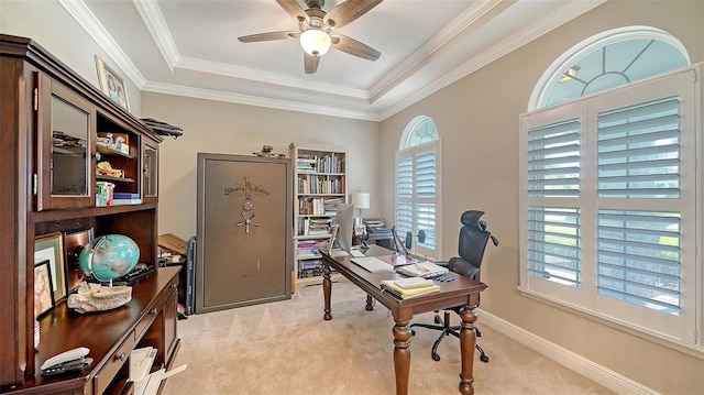 home office with baseboards, light carpet, ornamental molding, and a ceiling fan