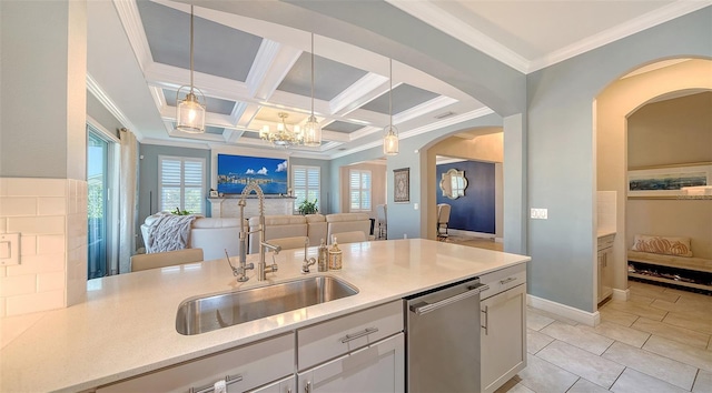 kitchen with open floor plan, stainless steel dishwasher, hanging light fixtures, coffered ceiling, and a sink