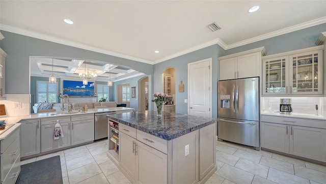 kitchen featuring visible vents, a sink, coffered ceiling, stainless steel appliances, and light tile patterned flooring