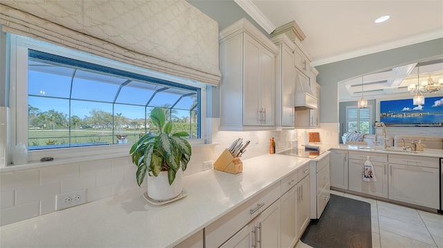 kitchen featuring light tile patterned flooring, ornamental molding, decorative backsplash, light countertops, and a sink