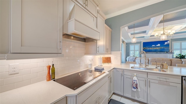 kitchen with premium range hood, coffered ceiling, plenty of natural light, a sink, and black electric cooktop