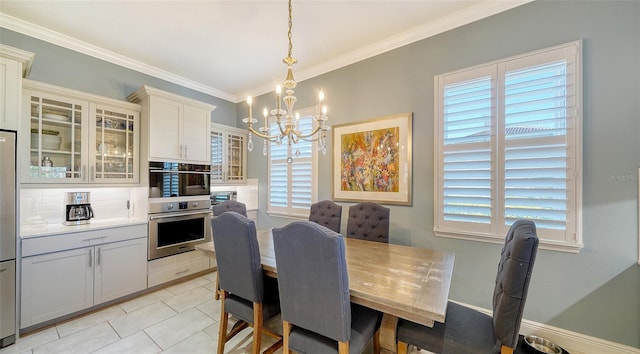 dining room with crown molding, a notable chandelier, and light tile patterned flooring