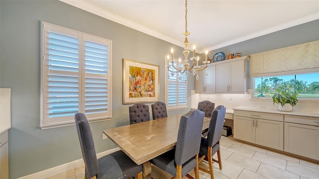 dining room with light tile patterned floors, baseboards, an inviting chandelier, and crown molding