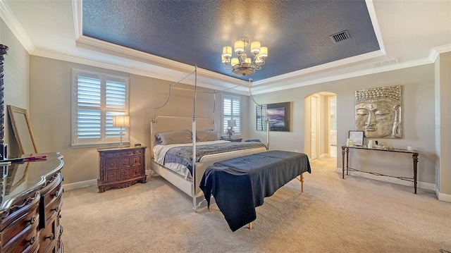 bedroom with arched walkways, visible vents, a tray ceiling, and carpet floors