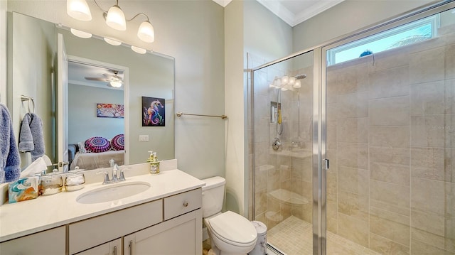 ensuite bathroom featuring vanity, ensuite bath, a stall shower, ornamental molding, and toilet