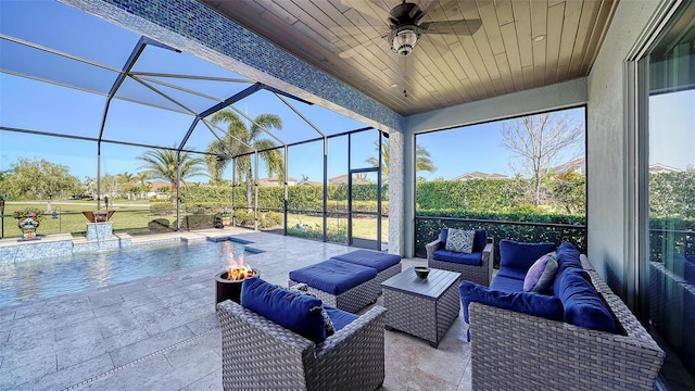 exterior space featuring an outdoor pool, glass enclosure, an outdoor living space with a fire pit, and a ceiling fan