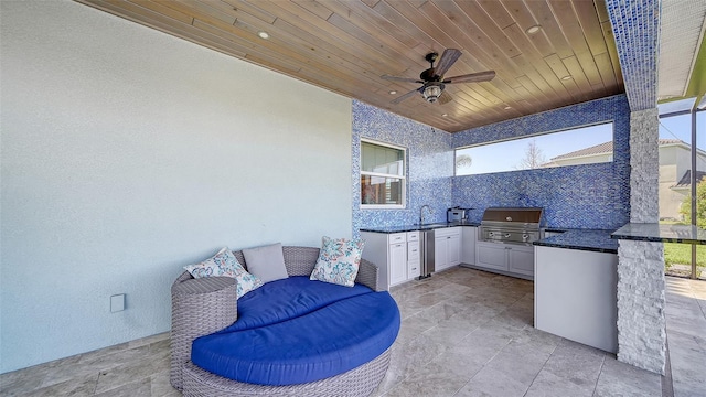 view of patio / terrace featuring a sink, exterior kitchen, area for grilling, and ceiling fan