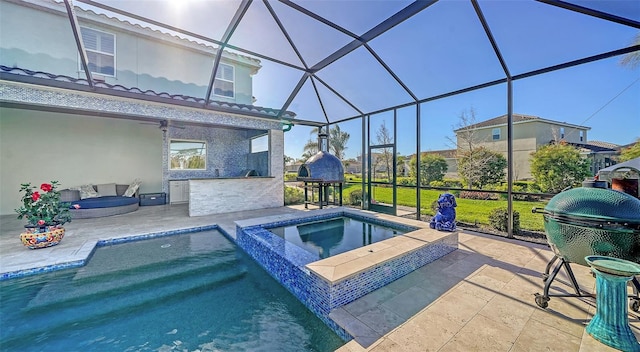 view of pool with glass enclosure, a patio, a pool with connected hot tub, and outdoor dry bar