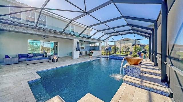 view of pool featuring a pool with connected hot tub, ceiling fan, a lanai, outdoor lounge area, and a patio