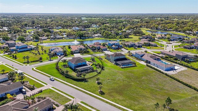 birds eye view of property with a water view and a residential view