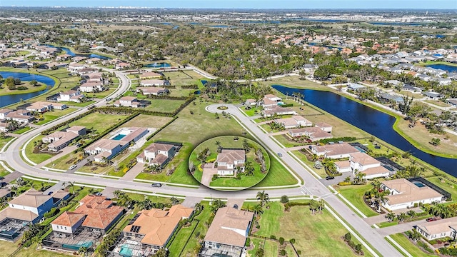 drone / aerial view with a residential view and a water view