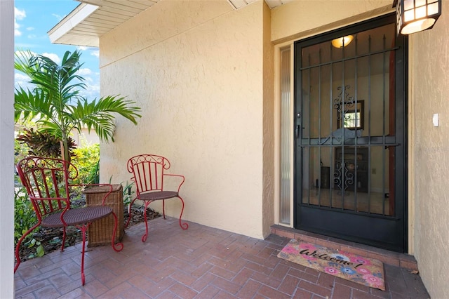 view of exterior entry featuring stucco siding