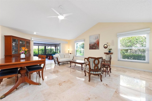 interior space featuring baseboards, a ceiling fan, and vaulted ceiling