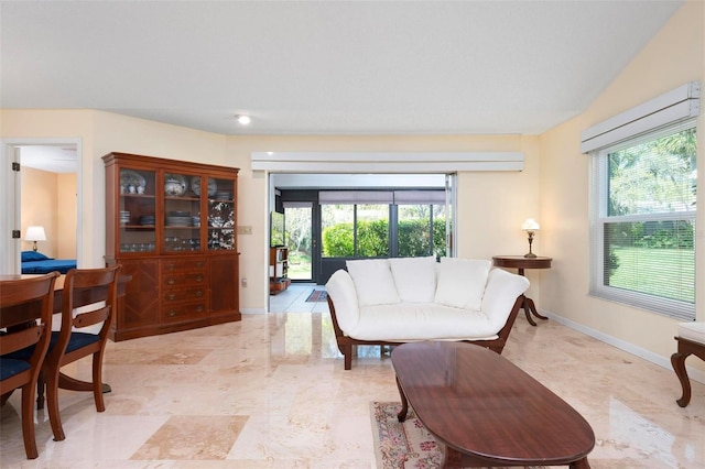 living area with plenty of natural light and baseboards