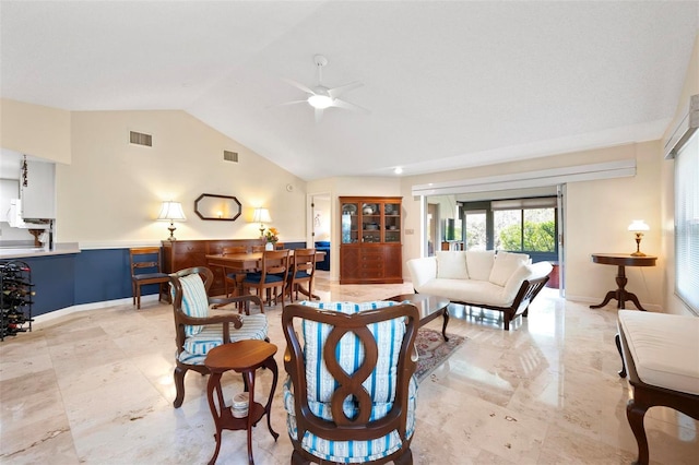 living room featuring visible vents, baseboards, ceiling fan, and vaulted ceiling