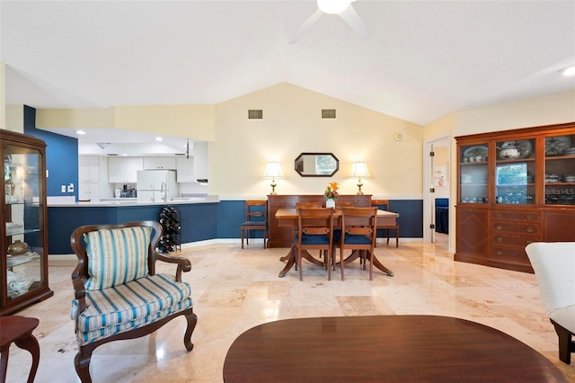 living room with visible vents, ceiling fan, baseboards, and lofted ceiling