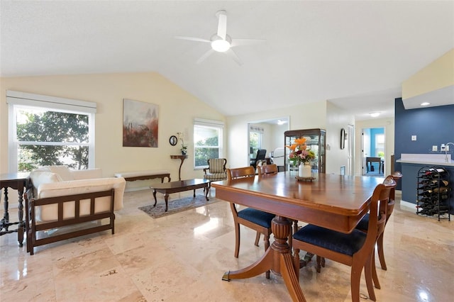 dining room featuring baseboards, ceiling fan, and vaulted ceiling