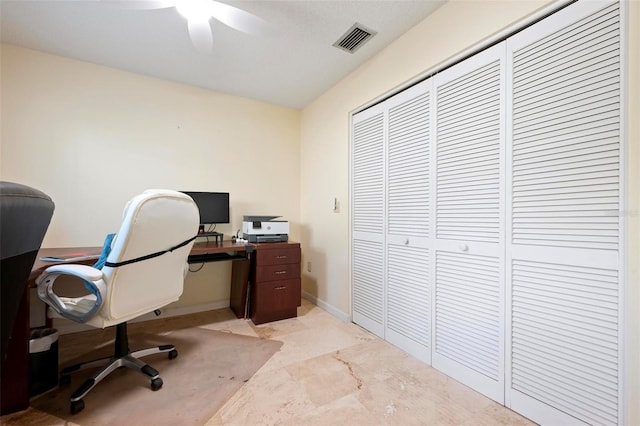 office space featuring visible vents, baseboards, and a ceiling fan