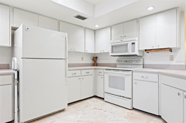 kitchen with visible vents, white appliances, white cabinets, and light countertops