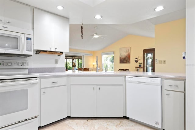 kitchen with white cabinets, white appliances, light countertops, and a sink