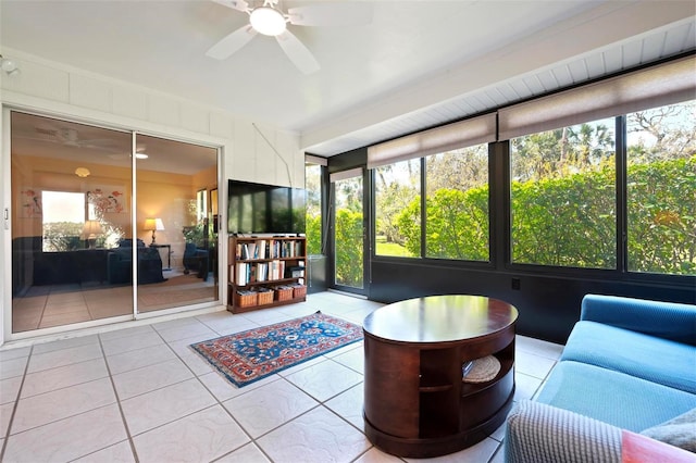 unfurnished sunroom with ceiling fan