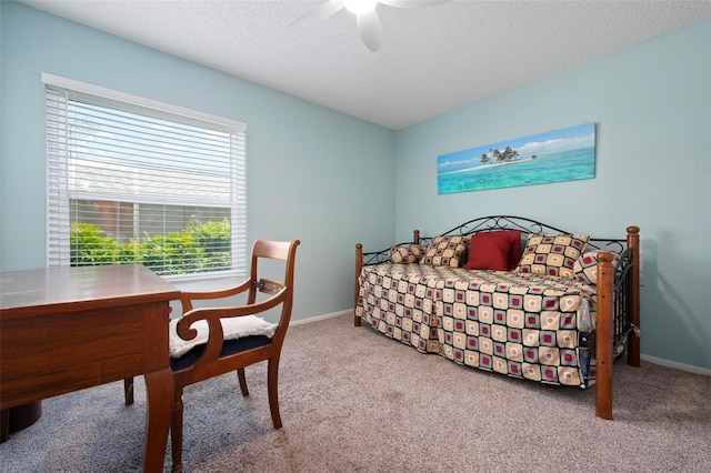 bedroom featuring baseboards, ceiling fan, a textured ceiling, and carpet