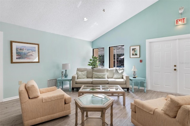 living area with light wood finished floors, high vaulted ceiling, a textured ceiling, and baseboards