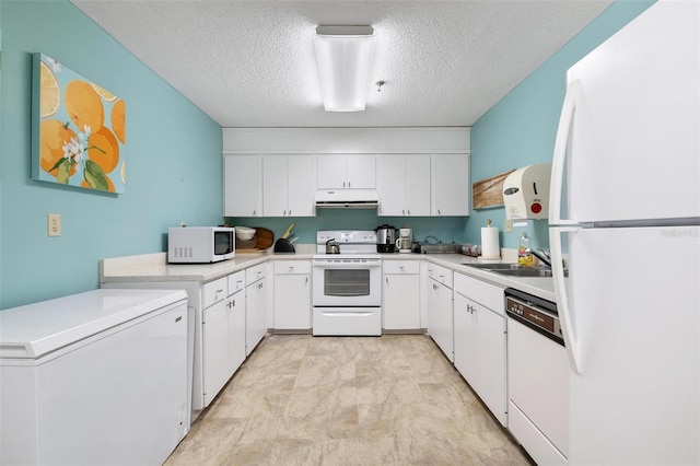 kitchen with white appliances, a peninsula, a sink, light countertops, and under cabinet range hood