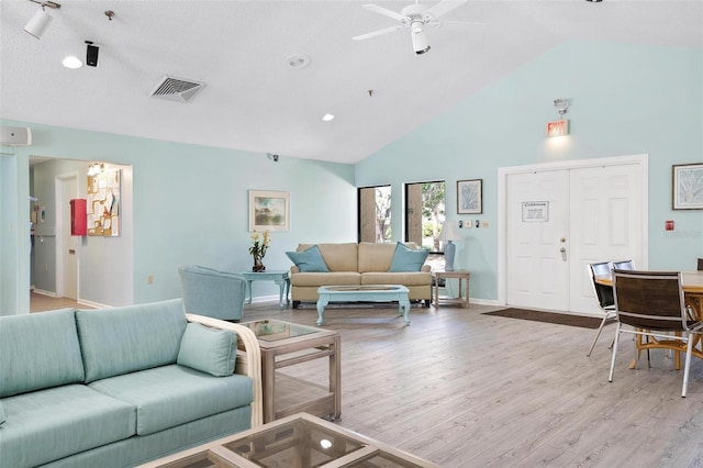 living room featuring visible vents, baseboards, wood finished floors, high vaulted ceiling, and a ceiling fan