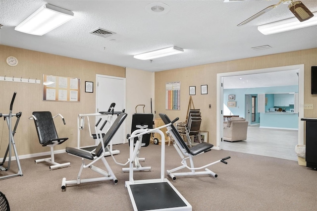 workout area with visible vents and a textured ceiling