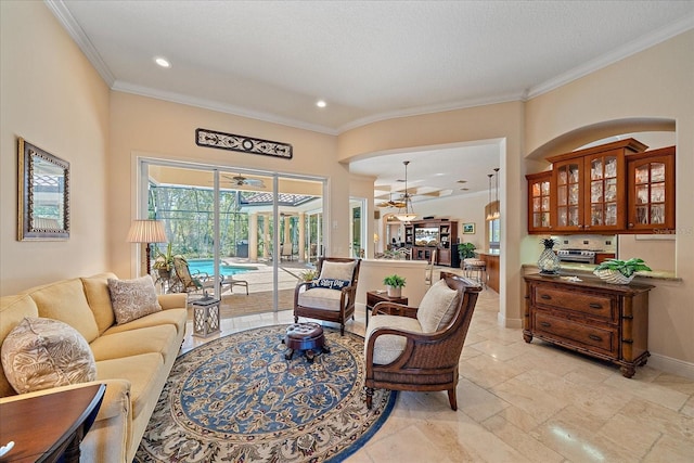 living area with recessed lighting, baseboards, a textured ceiling, and ornamental molding