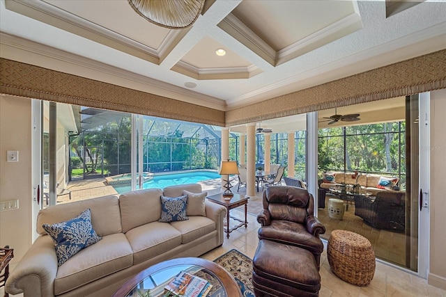 tiled living area with beamed ceiling, ornamental molding, coffered ceiling, a sunroom, and ceiling fan