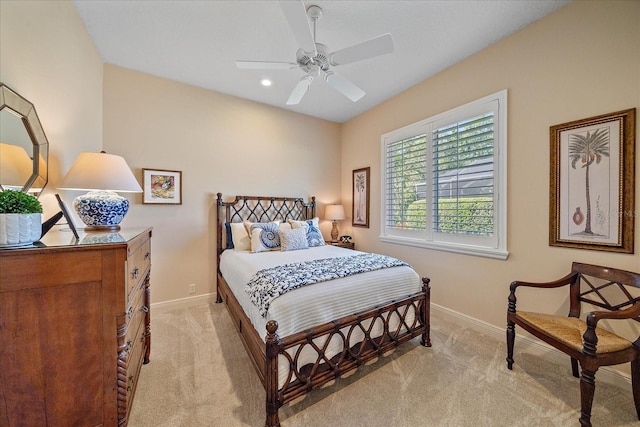 bedroom with light colored carpet and baseboards