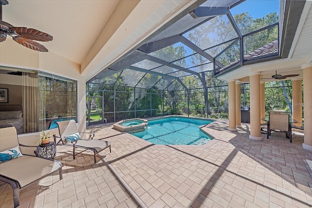 view of pool with a lanai, a pool with connected hot tub, ceiling fan, and a patio area