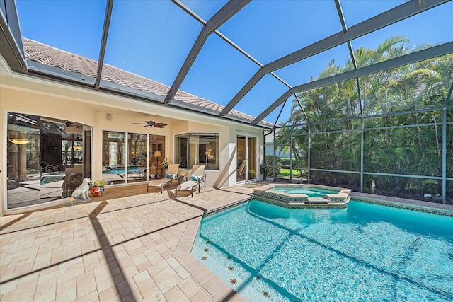 view of pool featuring a pool with connected hot tub, a lanai, a ceiling fan, and a patio area