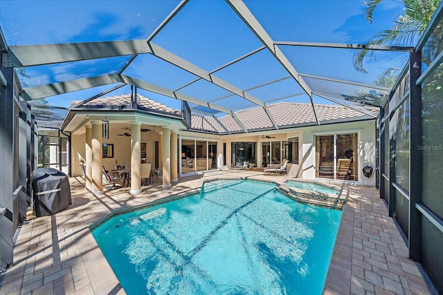 view of pool featuring ceiling fan, a pool with connected hot tub, and a patio