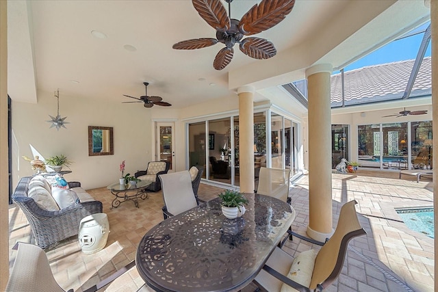 view of patio / terrace with a ceiling fan, an outdoor living space, outdoor dining area, an outdoor pool, and a lanai