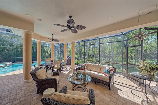 sunroom featuring ceiling fan