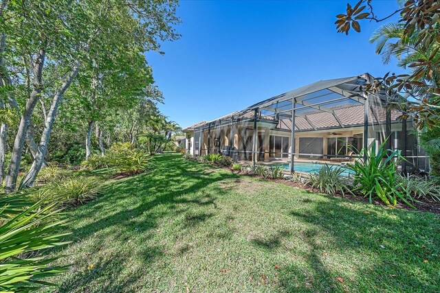 view of yard with a lanai and an outdoor pool