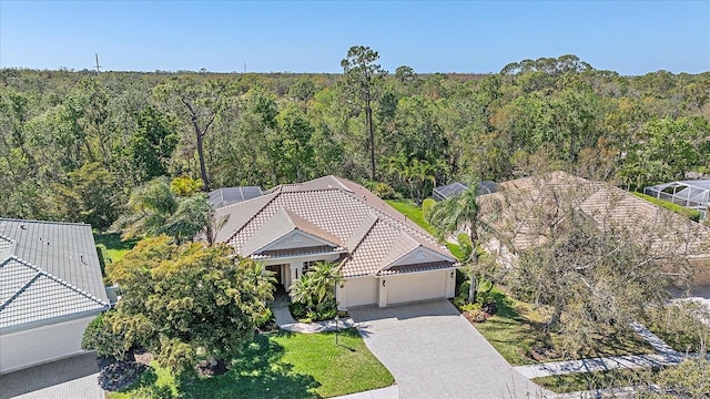 drone / aerial view with a wooded view