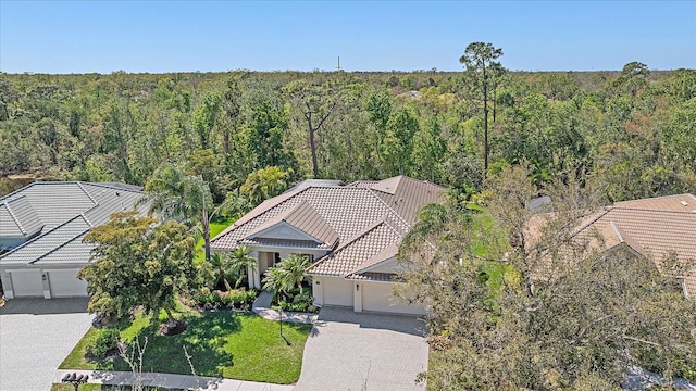 birds eye view of property with a forest view